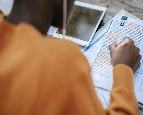 Student reading notes in soft light